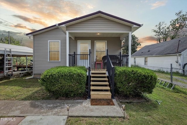 bungalow-style house with a porch and a lawn