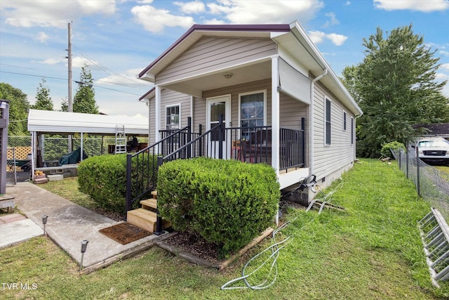 bungalow-style home featuring covered porch and a front lawn