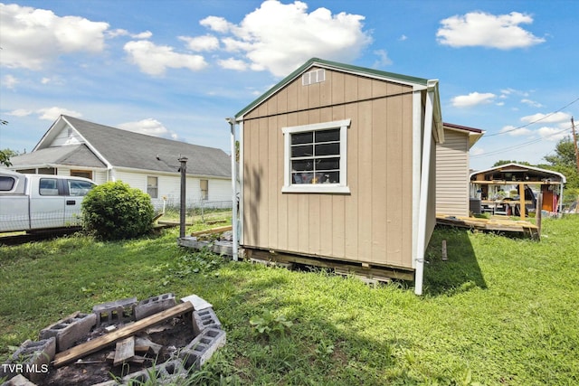 view of outbuilding featuring a lawn