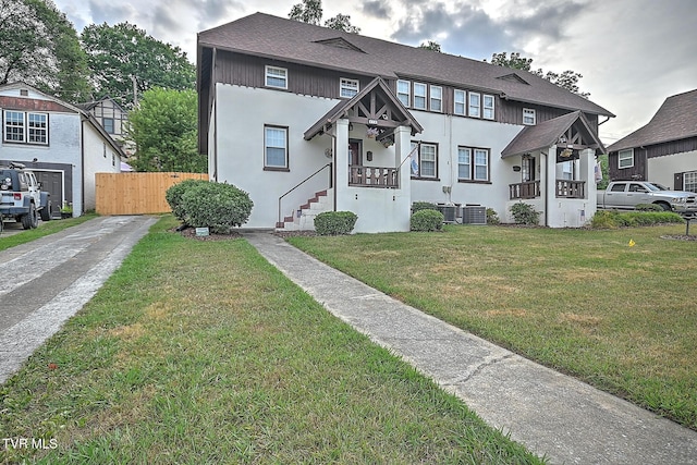 view of front of property with cooling unit and a front yard