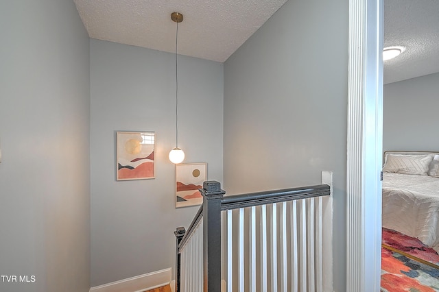 staircase with a textured ceiling