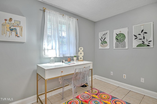 office area featuring light tile patterned flooring and a textured ceiling