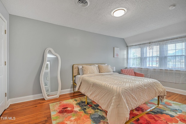 bedroom featuring hardwood / wood-style floors and a textured ceiling