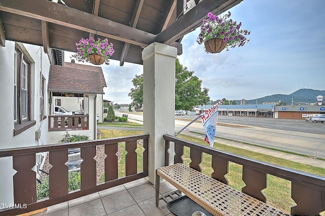 balcony with a mountain view and covered porch