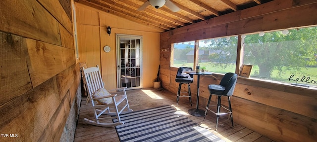 sunroom / solarium with lofted ceiling and ceiling fan