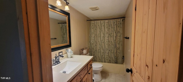 full bathroom with tile patterned flooring, vanity, shower / tub combo, toilet, and a textured ceiling