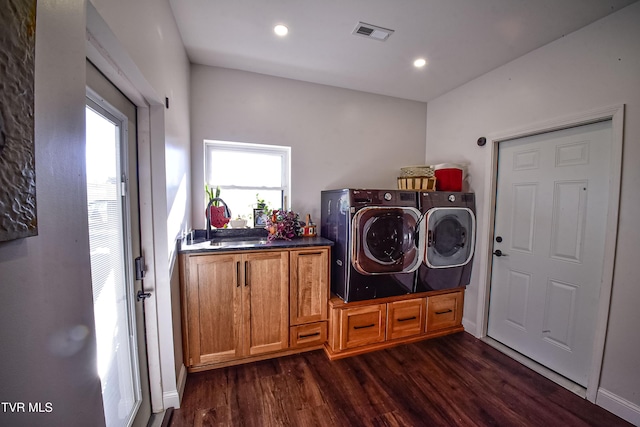 clothes washing area featuring cabinets, dark hardwood / wood-style flooring, sink, and washer and dryer