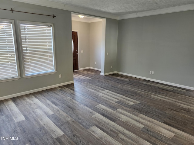 empty room featuring dark wood-type flooring, ornamental molding, and a textured ceiling