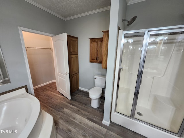 full bathroom featuring separate shower and tub, wood-type flooring, ornamental molding, a textured ceiling, and toilet