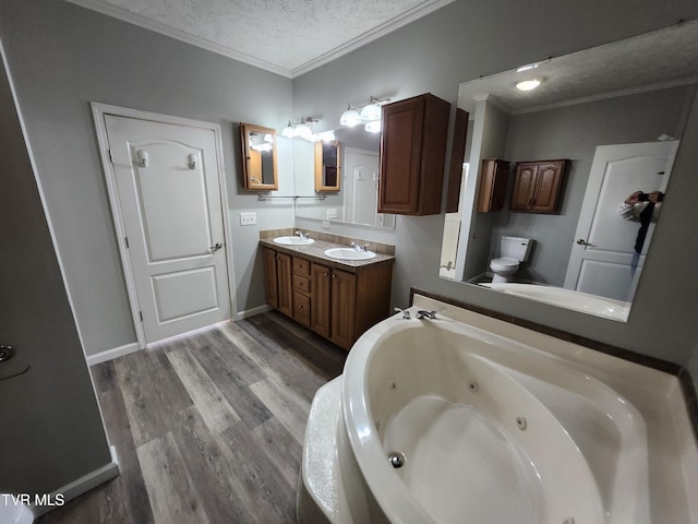 bathroom with toilet, crown molding, a textured ceiling, hardwood / wood-style flooring, and a washtub