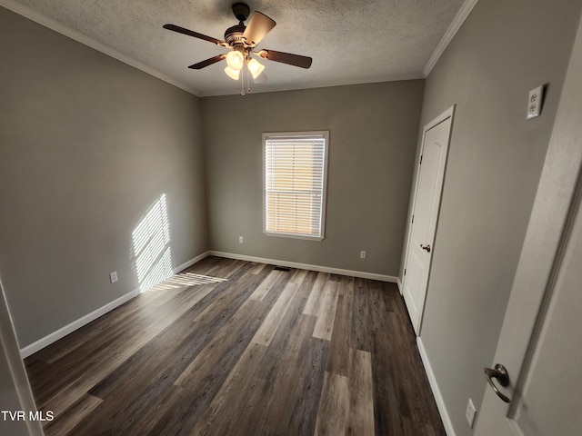 spare room featuring crown molding, dark wood-type flooring, ceiling fan, and a textured ceiling