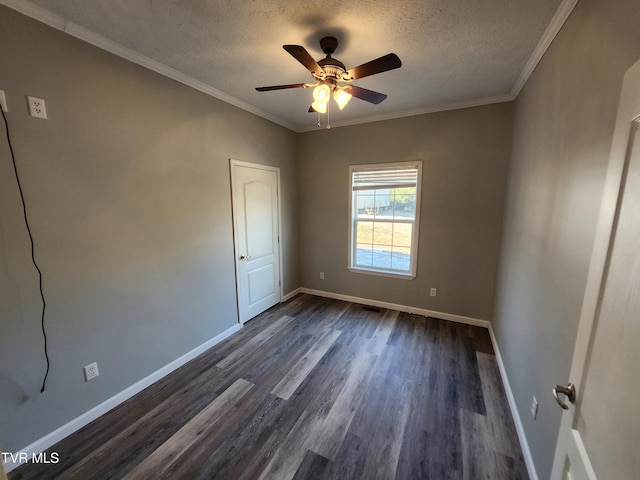 unfurnished room featuring dark wood-type flooring, ornamental molding, and a textured ceiling