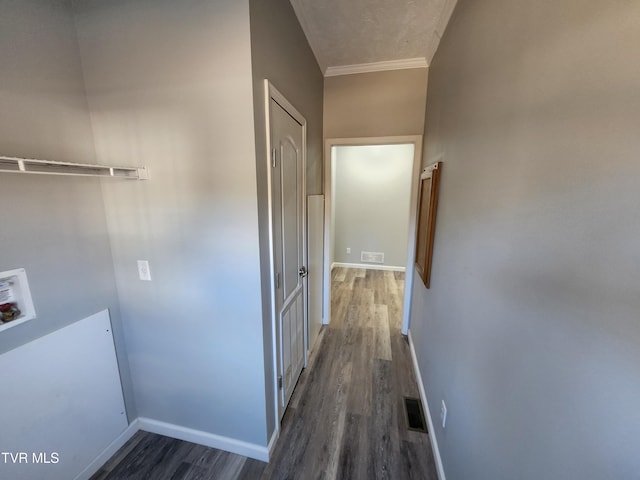 hallway featuring crown molding and dark hardwood / wood-style floors