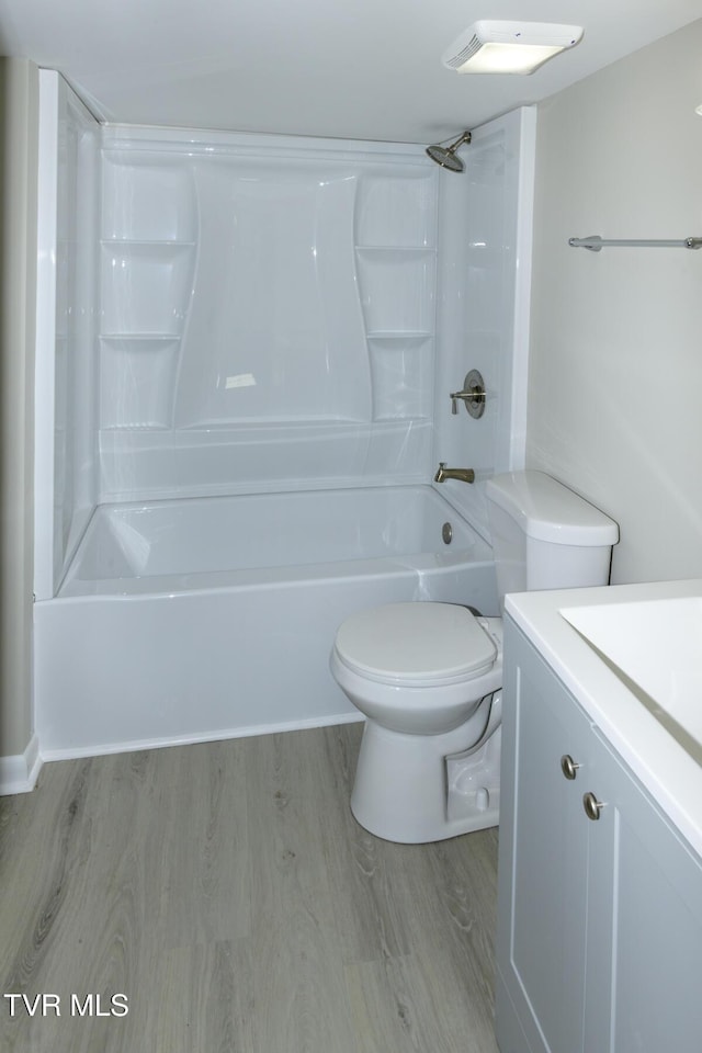 full bathroom featuring vanity, wood-type flooring, shower / bathtub combination, and toilet