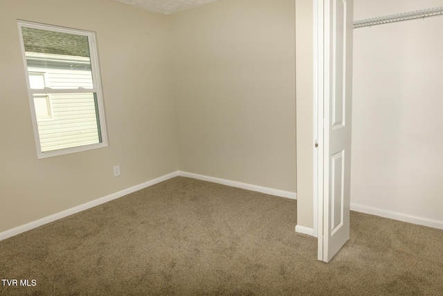 unfurnished bedroom featuring carpet flooring and a closet