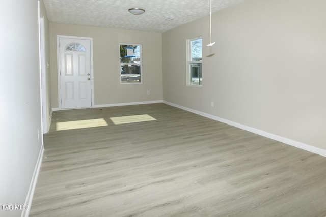 interior space with light hardwood / wood-style flooring and a textured ceiling