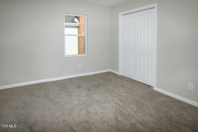 unfurnished bedroom featuring carpet floors and a closet