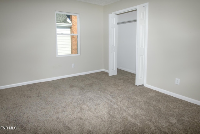 unfurnished bedroom featuring carpet floors and a closet