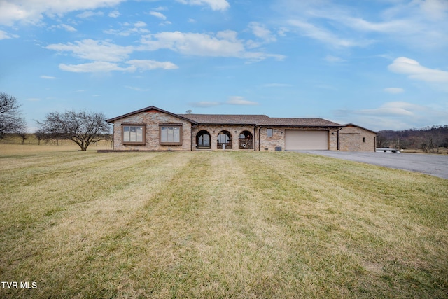 ranch-style home featuring a garage and a front yard