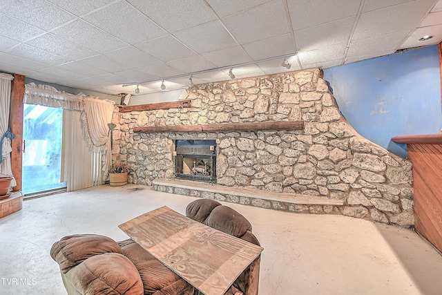 169 Church Cir, Bristol, TN 37620 - living room featuring concrete flooring, a fireplace, a drop ceiling, and rail lighting