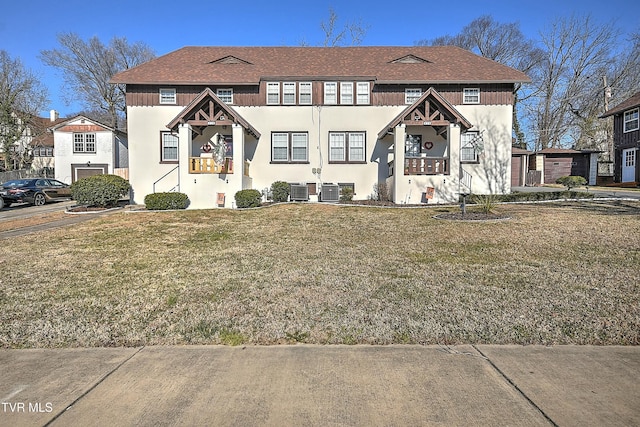 view of front facade with cooling unit and a front yard