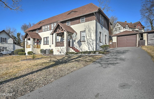 view of front facade featuring a garage, an outdoor structure, and a front yard