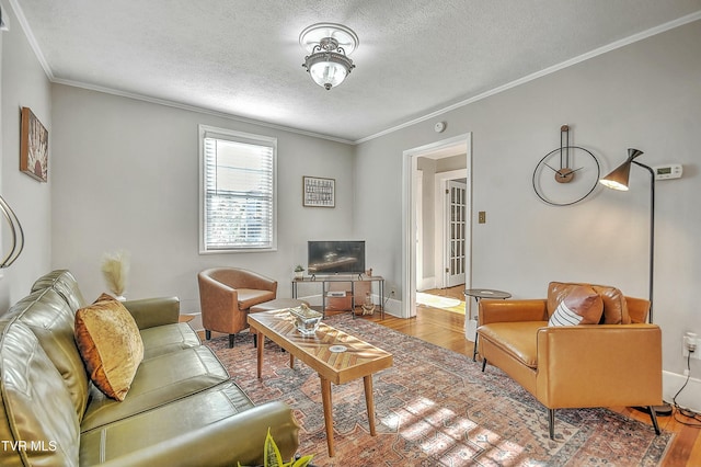 living room with crown molding, a textured ceiling, and light hardwood / wood-style floors