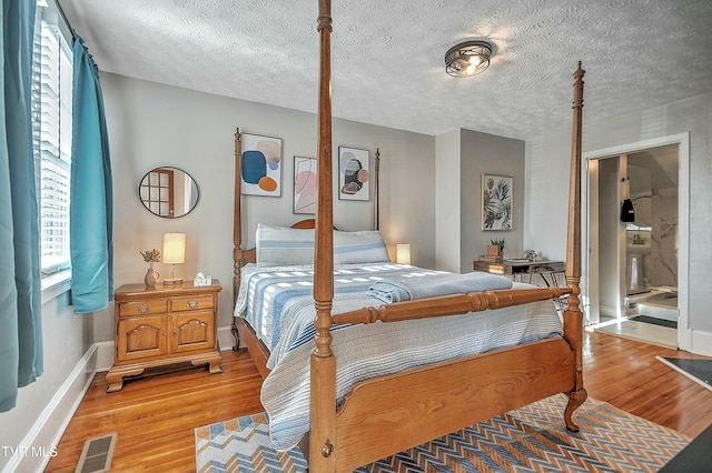 bedroom featuring hardwood / wood-style floors and a textured ceiling