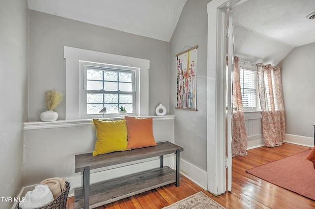 sitting room featuring lofted ceiling and hardwood / wood-style flooring