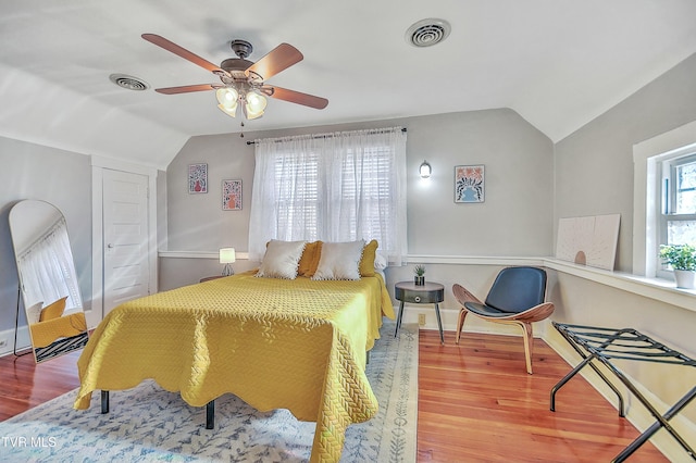 bedroom featuring hardwood / wood-style flooring, vaulted ceiling, and ceiling fan