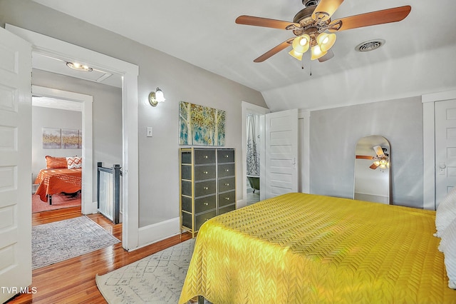 bedroom with lofted ceiling, wood-type flooring, and ceiling fan