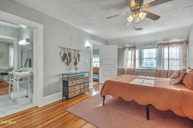 bedroom featuring hardwood / wood-style flooring and a textured ceiling