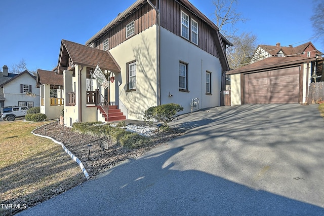 view of side of home featuring an outbuilding and a garage