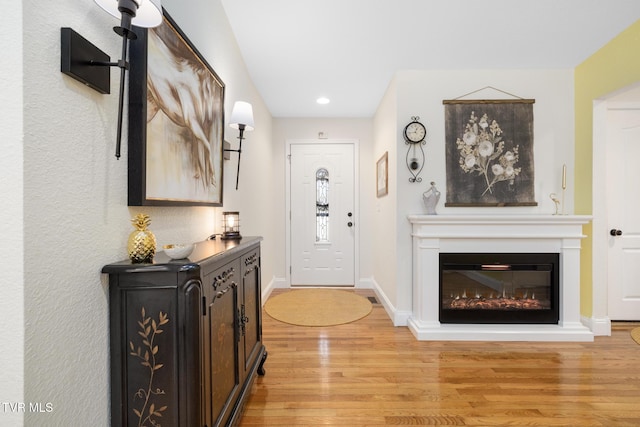 foyer entrance with light hardwood / wood-style floors