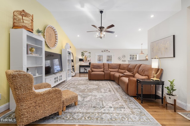 living room featuring lofted ceiling, hardwood / wood-style floors, and ceiling fan