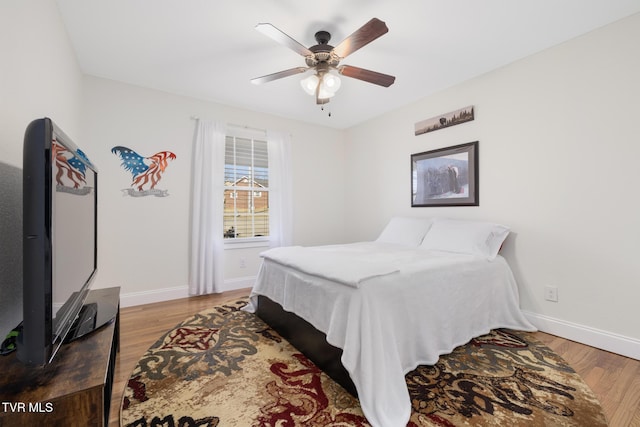 bedroom with hardwood / wood-style floors and ceiling fan