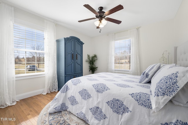 bedroom with hardwood / wood-style flooring and ceiling fan