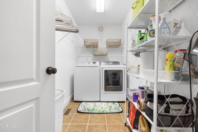 laundry room featuring washer and dryer and light tile patterned floors