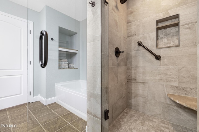 bathroom featuring plus walk in shower, built in features, and tile patterned floors