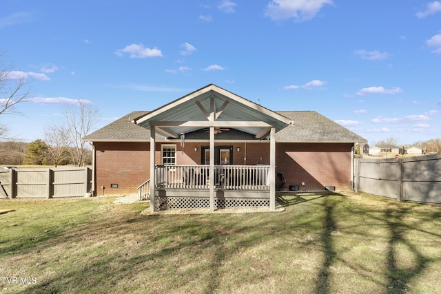 rear view of property with a lawn and a deck