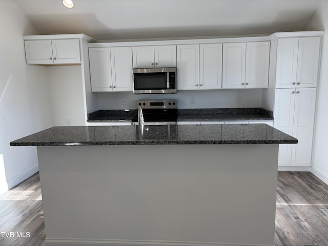 kitchen featuring an island with sink, white cabinets, and appliances with stainless steel finishes