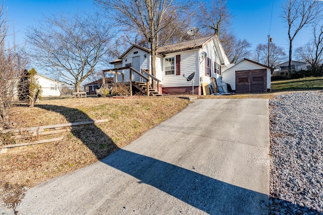 bungalow-style house with a storage shed and a front lawn