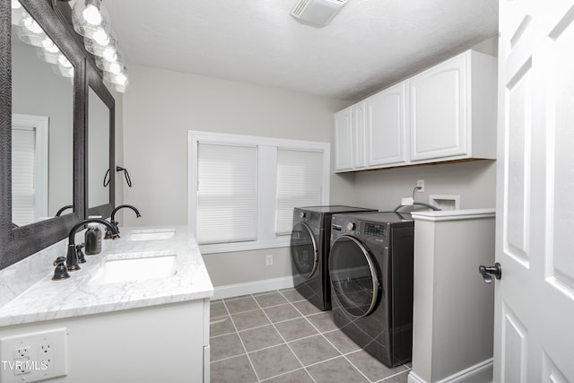 laundry area featuring cabinets, separate washer and dryer, sink, and light tile patterned floors