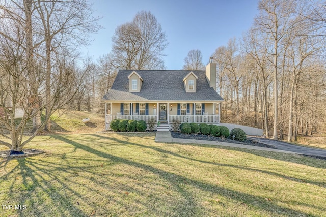 new england style home featuring a front yard and a porch