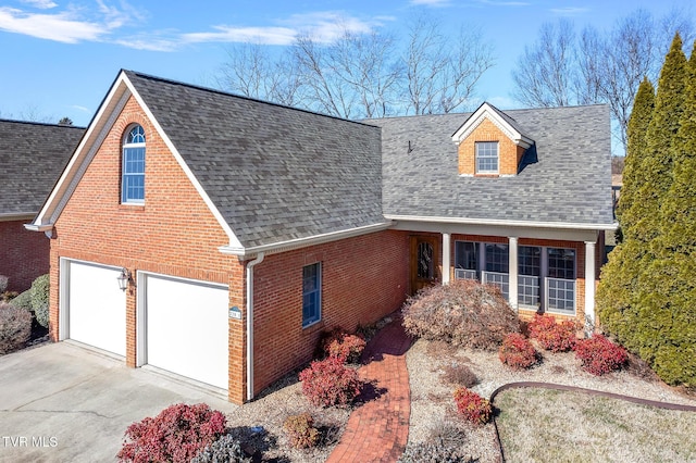 cape cod home with a garage