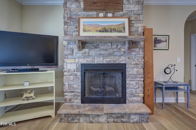 interior details featuring crown molding, hardwood / wood-style floors, and a fireplace