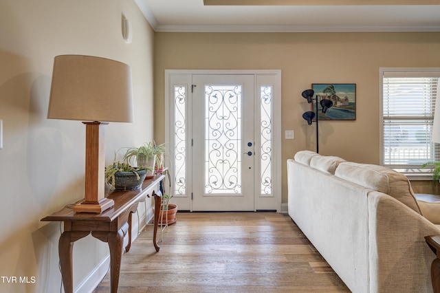 foyer featuring crown molding and light hardwood / wood-style floors