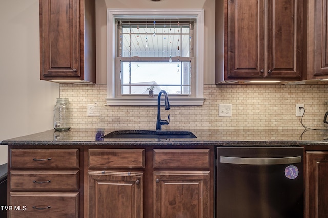 kitchen with dark brown cabinetry, sink, dark stone counters, and dishwasher