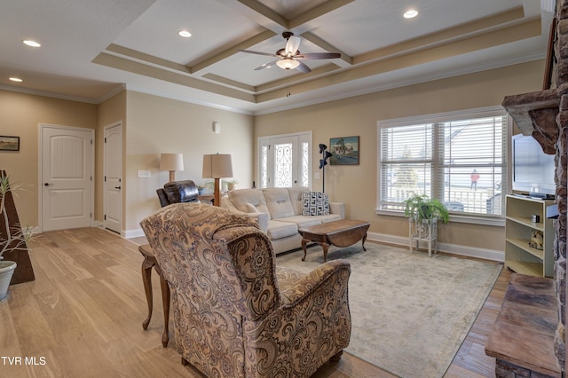 living room featuring beamed ceiling, ornamental molding, coffered ceiling, ceiling fan, and light hardwood / wood-style flooring