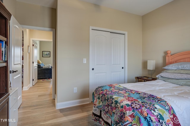 bedroom featuring a closet and light hardwood / wood-style flooring